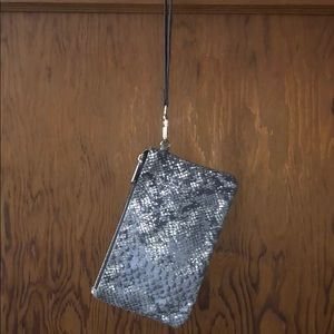 Hand held rechargeable wallet with wrist band.